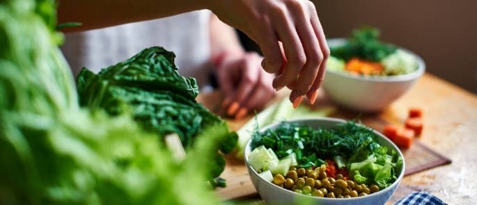 Woman seasoning a healthy salad