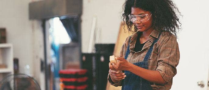 A construction worker preparing to use a grinding machine