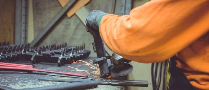 Worker carrying out hot work sawing