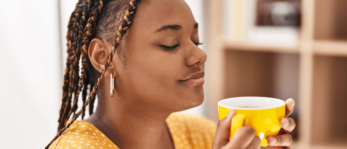 Woman enjoying a caffeinated hot drink