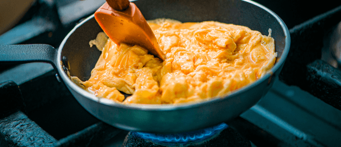 Cooking eggs in a pan.