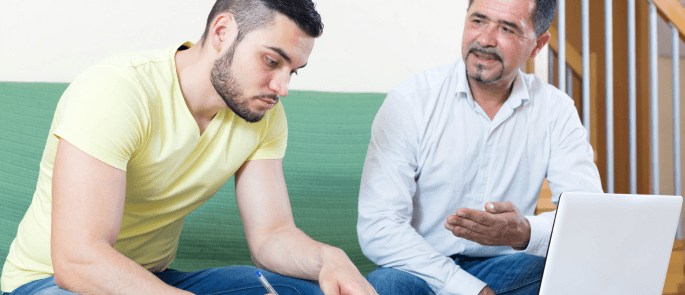 Vulnerable adult on computer with his carer